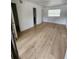 Bright bedroom with wood-look floors and access to bathroom at 10232 Turkey Lake Rd # 181, Orlando, FL 32819