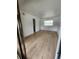 Bright bedroom with wood-look floors and access to bathroom at 10232 Turkey Lake Rd # 181, Orlando, FL 32819