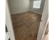 Bright bedroom with light wood-look flooring and a window with blinds at 10232 Turkey Lake Rd # 181, Orlando, FL 32819