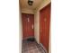 Shared entryway with two red doors and tile flooring at 10232 Turkey Lake Rd # 181, Orlando, FL 32819