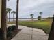 Peaceful lake view with lush landscaping and palm trees at 10232 Turkey Lake Rd # 181, Orlando, FL 32819