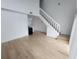 Spacious living room with wood-look floors and staircase at 10232 Turkey Lake Rd # 181, Orlando, FL 32819