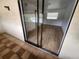 View of a patio with sliding glass doors leading to a bright, airy room with wood-look flooring at 10232 Turkey Lake Rd # 181, Orlando, FL 32819