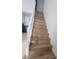 Modern staircase with light wood risers and white railings at 10232 Turkey Lake Rd # 181, Orlando, FL 32819