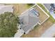 An aerial close-up view of the home, pool, and surrounding landscape at 103 Vega Ct, Davenport, FL 33896