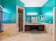 Bathroom with teal walls, granite countertops, and a large soaking tub at 103 Vega Ct, Davenport, FL 33896