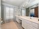 Bathroom with double vanity and large mirror at 103 Vega Ct, Davenport, FL 33896