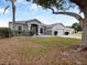 One-story home with a two-car garage and mature landscaping at 103 Vega Ct, Davenport, FL 33896