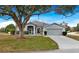 Charming one-story home with a large tree and driveway at 103 Vega Ct, Davenport, FL 33896
