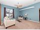 Cozy Gathering room featuring a ceiling fan and large windows at 103 Vega Ct, Davenport, FL 33896