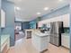 Modern kitchen with stainless steel appliances and blue walls at 103 Vega Ct, Davenport, FL 33896