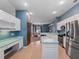 Spacious kitchen featuring stainless steel appliances and an island at 103 Vega Ct, Davenport, FL 33896
