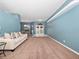Spacious living room with beige couch and entryway view at 103 Vega Ct, Davenport, FL 33896