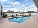 Inviting screened-in pool with a large patio area at 103 Vega Ct, Davenport, FL 33896