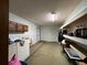 Unfinished basement with laundry area and storage shelving at 1085 Old Hickory Tree Rd, St Cloud, FL 34771