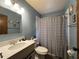 Bathroom with tub shower combo, vanity and grey shower curtain at 1085 Old Hickory Tree Rd, St Cloud, FL 34771