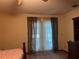 Bedroom with queen bed, access to backyard and dresser at 1085 Old Hickory Tree Rd, St Cloud, FL 34771