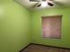 Bright bedroom with light green walls and window blinds at 1085 Old Hickory Tree Rd, St Cloud, FL 34771