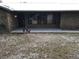 Covered porch with brick flooring and a view of the front yard at 1085 Old Hickory Tree Rd, St Cloud, FL 34771