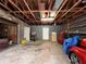 Unfinished garage with open door, showing storage and a vehicle at 1085 Old Hickory Tree Rd, St Cloud, FL 34771
