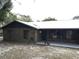 Side view of brick ranch house with backyard and trees at 1085 Old Hickory Tree Rd, St Cloud, FL 34771