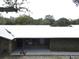 Brick ranch house with metal roof, covered porch, and large backyard at 1085 Old Hickory Tree Rd, St Cloud, FL 34771