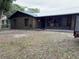 Back view of brick ranch house with spacious backyard at 1085 Old Hickory Tree Rd, St Cloud, FL 34771