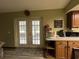 Kitchen with French doors leading to a screened porch and pool area at 1085 Old Hickory Tree Rd, St Cloud, FL 34771