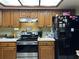 Kitchen with wood cabinets and black appliances at 1085 Old Hickory Tree Rd, St Cloud, FL 34771