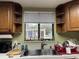 Kitchen sink with wood cabinets and backyard view at 1085 Old Hickory Tree Rd, St Cloud, FL 34771
