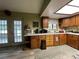 Kitchen with wood cabinets, appliances, and access to the backyard at 1085 Old Hickory Tree Rd, St Cloud, FL 34771