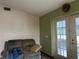 Living room with French doors leading to a patio and a couch at 1085 Old Hickory Tree Rd, St Cloud, FL 34771