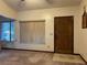 Living room with wood door and window blinds at 1085 Old Hickory Tree Rd, St Cloud, FL 34771
