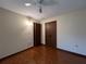 Bright bedroom featuring wood floors and double doors at 1186 Laguna Cir, St Cloud, FL 34771