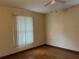 Bright bedroom with wood floors and window coverings at 1186 Laguna Cir, St Cloud, FL 34771