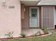 Front door with glass panels and landscaping at 1186 Laguna Cir, St Cloud, FL 34771