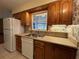 Kitchen features wood cabinets, a double sink, and a window view at 1186 Laguna Cir, St Cloud, FL 34771