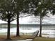 Picturesque view of the lake with a dock and sandhill cranes at 1186 Laguna Cir, St Cloud, FL 34771