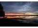 Stunning sunset over the lake, reflecting vibrant colors at 1186 Laguna Cir, St Cloud, FL 34771