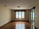 Living room with hardwood floors, water view, and sliding doors at 1186 Laguna Cir, St Cloud, FL 34771