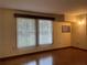 Bright living room with hardwood floors and large windows at 1186 Laguna Cir, St Cloud, FL 34771