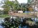 Lakefront property with lush landscaping and reflection at 1186 Laguna Cir, St Cloud, FL 34771