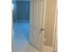Open door view of a bright bedroom with white flooring at 14429 Wabasso Loop, Winter Garden, FL 34787