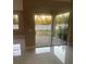 View of backyard through sliding glass doors from dining room at 14429 Wabasso Loop, Winter Garden, FL 34787