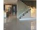 Modern interior with open concept floor plan, kitchen, and glass staircase at 14429 Wabasso Loop, Winter Garden, FL 34787