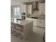 Modern kitchen with white cabinets and a large island at 14429 Wabasso Loop, Winter Garden, FL 34787