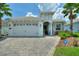 Two-story home with tile roof, stone accents, and a two-car garage at 1446 Bunker Dr, Davenport, FL 33896