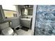 Updated bathroom with double vanity, shower, and marble-look floor at 14636 Bray Rd, Orlando, FL 32832