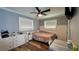 Bright bedroom featuring a double bed, built-in shelving, and wood-look floors at 14636 Bray Rd, Orlando, FL 32832