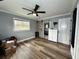 Bedroom with hardwood floors and sliding barn door at 14636 Bray Rd, Orlando, FL 32832